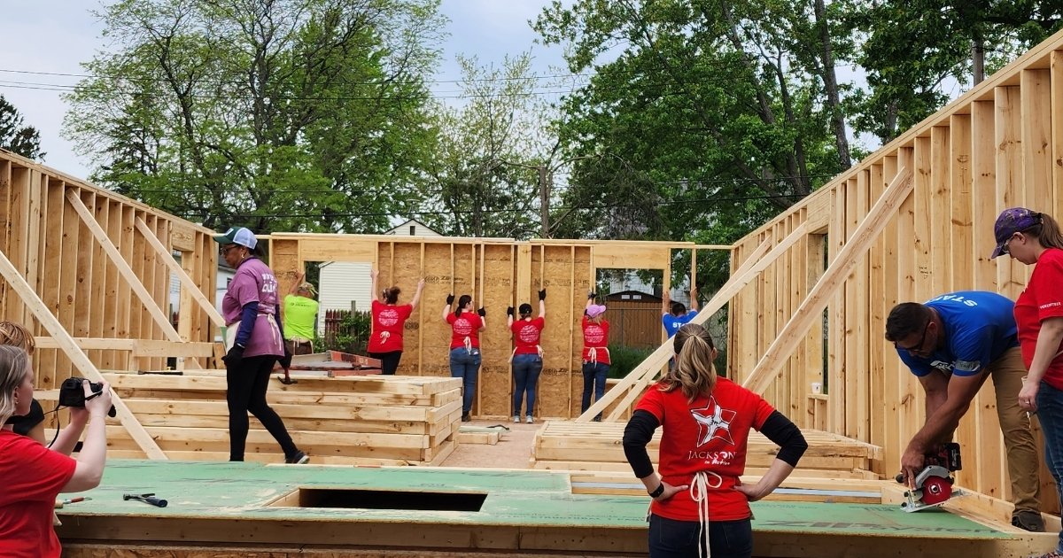 Volunteers raise the walls of Brittni's Habitat home.