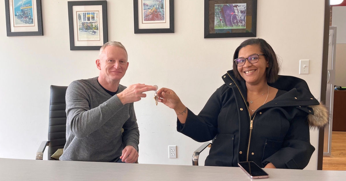 Closing on Brittni's Family home: Brent Taylor, Habitat Capital Region CEO, officially hands over the keys to Brittni after she closed on her Habitat house.