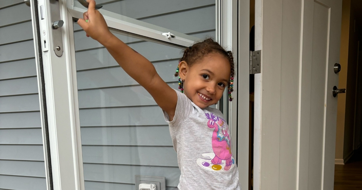 Carly's Home Base: Carly's youngest child smiles in the doorway of their new house on move in day!