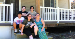 Rebellia's Home Dedication: The family smiles for a photos on their future front steps.